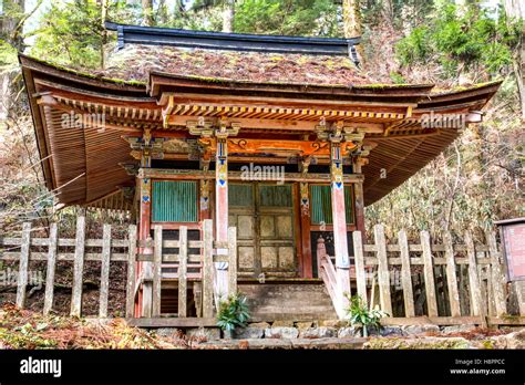 Japan, Koyasan, Okunoin cemetery. Weathered wooden painted Mausoleum hall or pavilion, marking ...