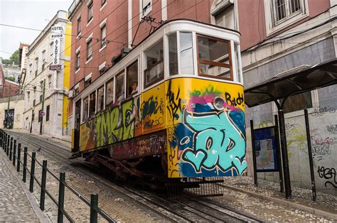 Lisbon tram on hill - Travel Inspires