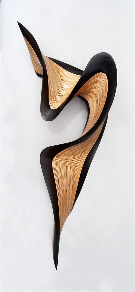 two pieces of art made out of wood on a white surface with black and ...