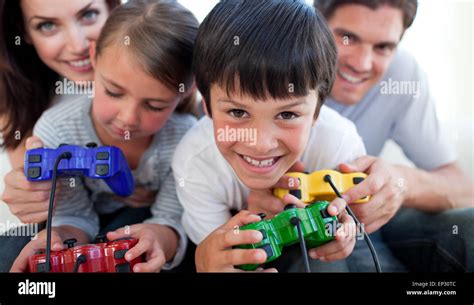 Parents playing video games with their children Stock Photo - Alamy