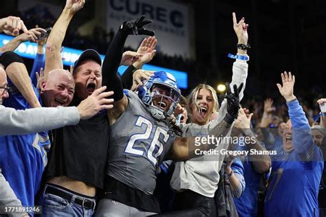 Jahmyr Gibbs of the Detroit Lions celebrates with fans in the front ...