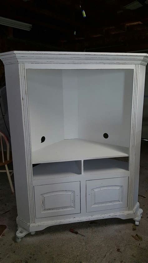 Redone this old entertainment center in distressed white with dark ...