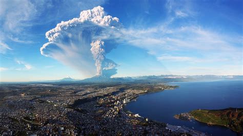 cityscape city building chile nature volcano eruption smoke mountain snowy peak water sea hill ...