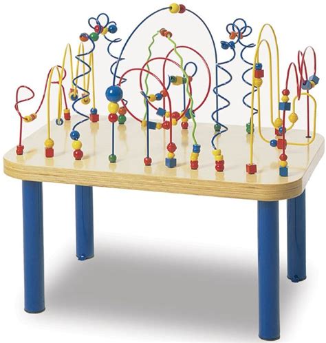 a child's wooden table with many colorful beads and shapes on it, along ...