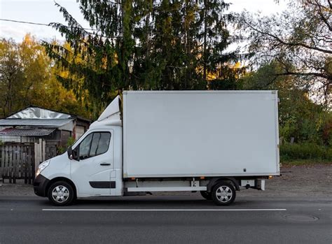 Premium Photo | White cargo van on the street Goods delivery