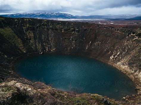 "Crater Filled With Water" by Stocksy Contributor "Martin Matej" - Stocksy