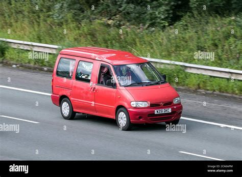 A 2000 Nissan Vanette Cargo Red LCV Window Van Diesel driving on the M6 ...