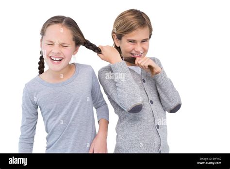 Angry young boy pulling sister hair in a fight Stock Photo - Alamy