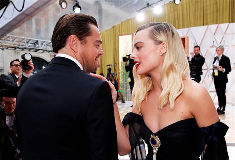 Margot Robbie hugs ex co-star Leonardo DiCaprio in touchy-feely reunion ...