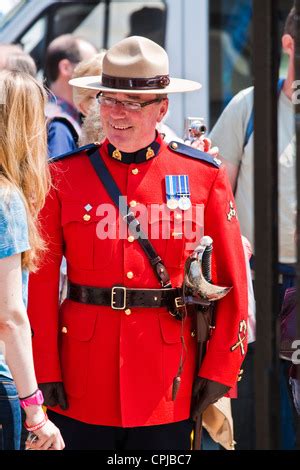 Royal Canadian Mounted Police in red serge ceremonial uniforms preparing to participate in ...