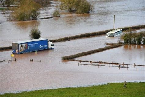 A lorry and a coach submerged in floodwater from the River Teme in ...