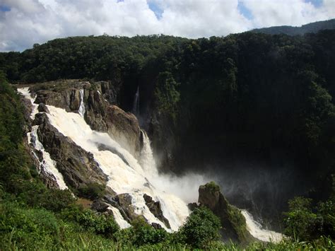 a large waterfall in the middle of a forest