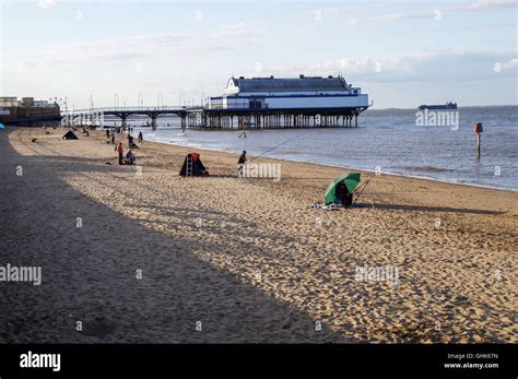 Fishing from Cleethorpes beach with pier in the background Stock Photo - Alamy