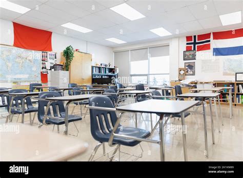 Desks and international flags in empty high school classroom Stock Photo - Alamy