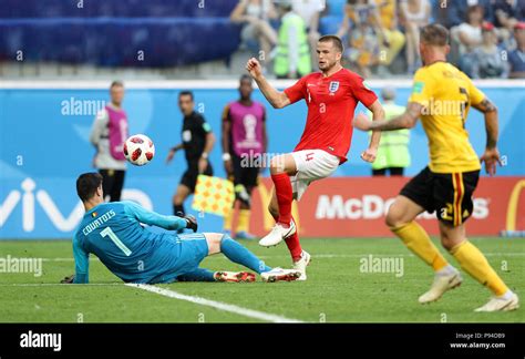 England's Eric Dier lifts the ball over Belgium goalkeeper Thibaut ...