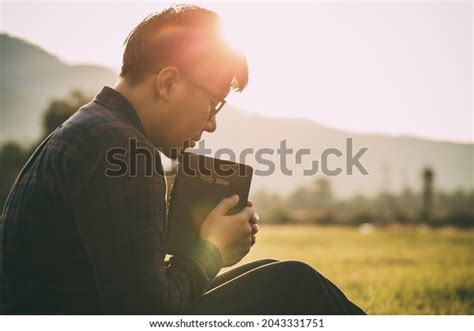 Man Praying On Holy Bible Field Stock Photo 2043331751 | Shutterstock