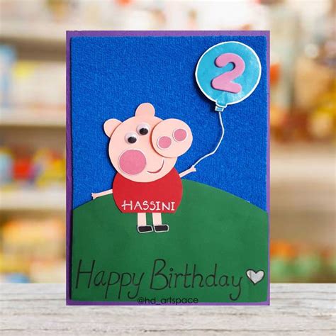a happy birthday card with a pig holding a balloon and the number two on it