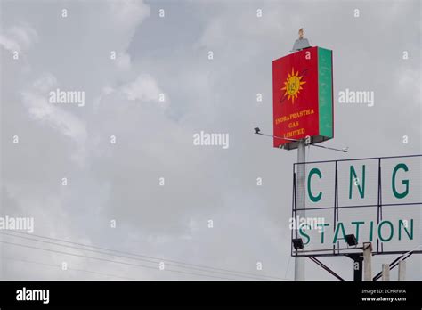 signboard of Indraprastha gas limited CNG station shot against a cloudy ...