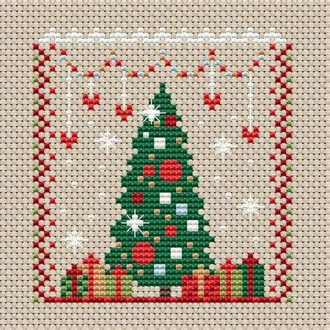 a cross stitch christmas tree with santa on it