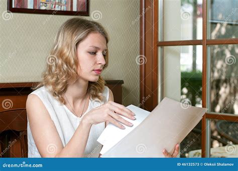 Girl Reading the Documents while Sitting Near the Window Stock Image ...