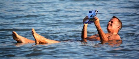 Man Floating In A Glassy Water Of Dead Sea Stock Photo - Image of salted, space: 19919242