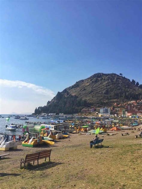 the beach is crowded with people and inflatable rafts on a sunny day