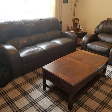 Two brown reclining sofas brown leather plus one solid wood coffee table and two solid side ...