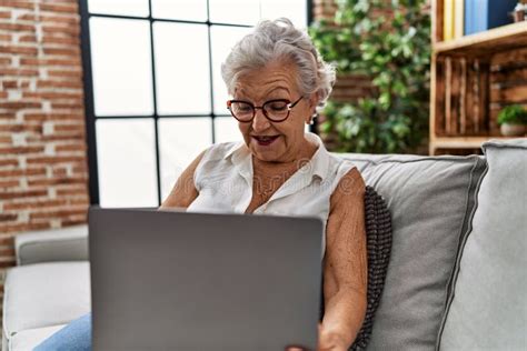 Senior Grey-haired Woman Using Laptop Sitting on Sofa at Home Stock Image - Image of glasses ...