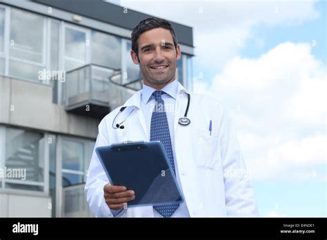 Doctor standing outside hospital Stock Photo - Alamy