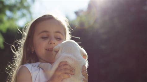 Free stock video - Close-up view of a caucasian little girl spinning around while holding a ...