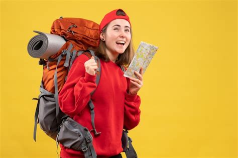 Free Photo | Front view cheerful female backpacker holding travel map