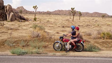 Couple riding motorcycle stop on side of road - HD stock video clip