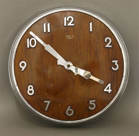 An Art Deco 'Smith Sectric' wall clock, with an oak convex dial, chrome ...