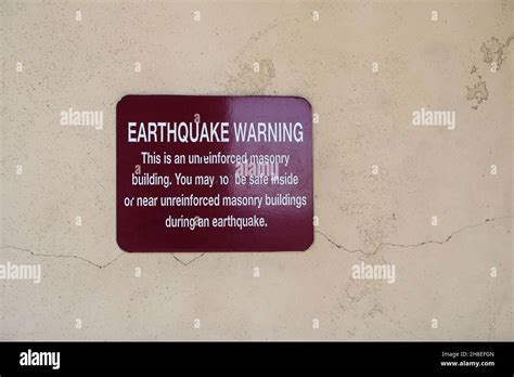 Earthquake warning sign on exterior wall of an old building in El Cajon ...