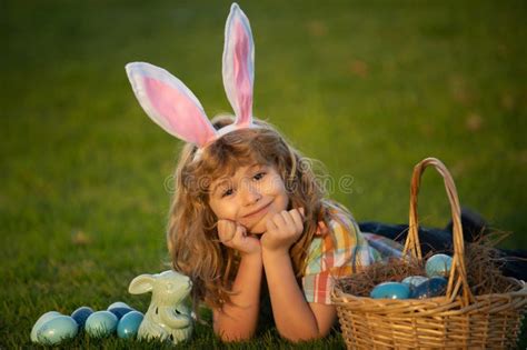 Child Boy Hunting Easter Eggs, Laying on Grass. Easter Bunny Children. Bunny Kids with Rabbit ...