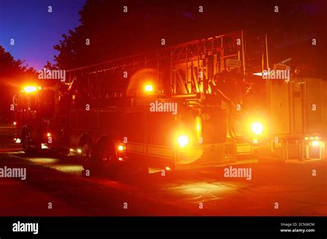 Fire truck with flashing emergency warning lights a response scene on a street at night Stock ...