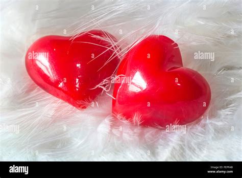 Two hearts together in white feathers Stock Photo - Alamy