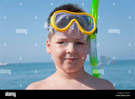 boy child sea goggles mask snorkel scuba swimming summer day sunny vacation resort portrait ...