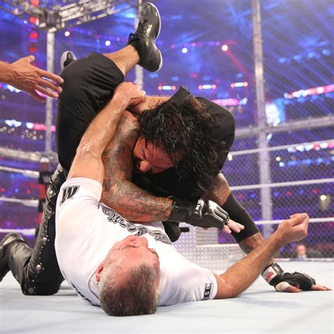 Shane gets Undertaker in a triangle submission causing him to foam and fade but it isn't enough ...