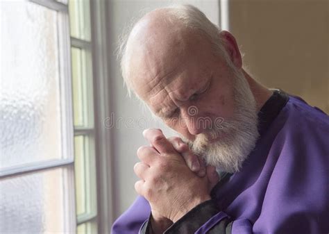 Priest Praying in a Church with a Thoughtful Expression Stock Photo ...