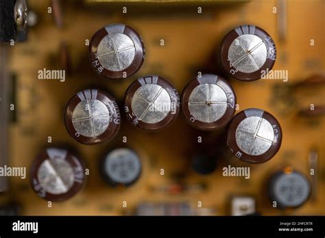 Damaged and inflated electrolytic capacitors Stock Photo - Alamy