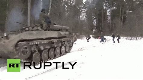 Russia: See daredevil snowboarders pulled by BMP infantry fighting vehicle animated gif