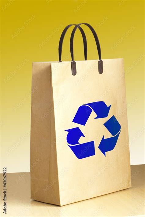 Recycle logo on paper bag on wooden Stock Photo | Adobe Stock