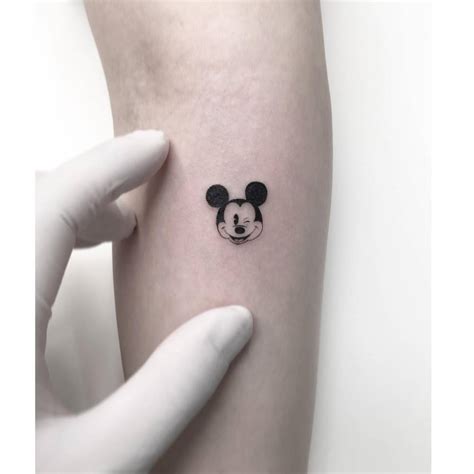 Mickey Mouse portrait tattoo located on the forearm.