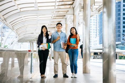 Premium Photo | Full length of students friends walking together in college campus