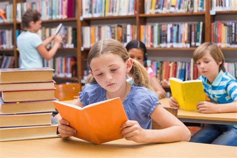 Cute Pupils Reading In Library Stock Photo - Image: 50495346