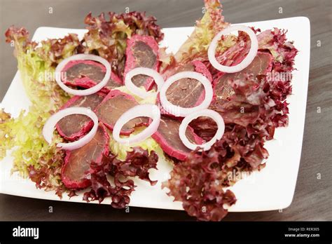 basturma with spices and onions on salad leaves Stock Photo - Alamy