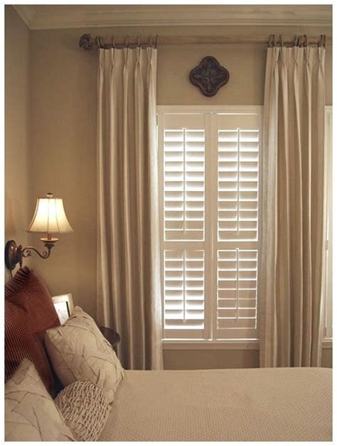 Beautiful wood blinds complemented with neutral drapes. A functional and traditional window cov ...