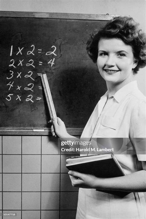 SCHOOLTEACHER POINTS TO MULTIPLICATION TABLE ON BLACKBOARD News Photo - Getty Images