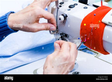 Hands work a sewing machine Stock Photo - Alamy